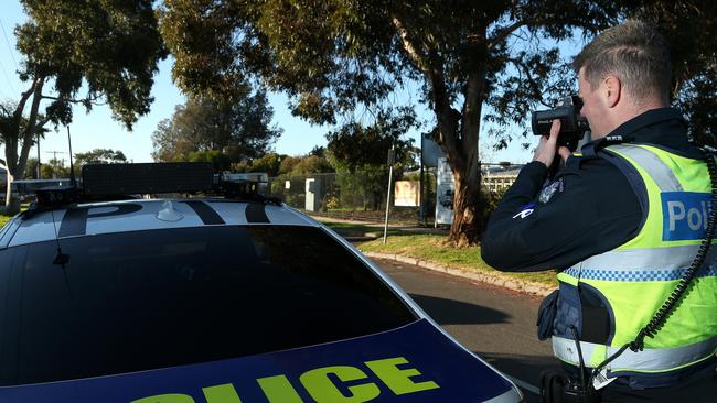 Acting Sergeant Stephen Little monitors traffic speed on York Street outside Glenroy West Primary School on Tuesday, June 9, 2020, in Glenroy, Victoria, Australia. Picture: Hamish Blair