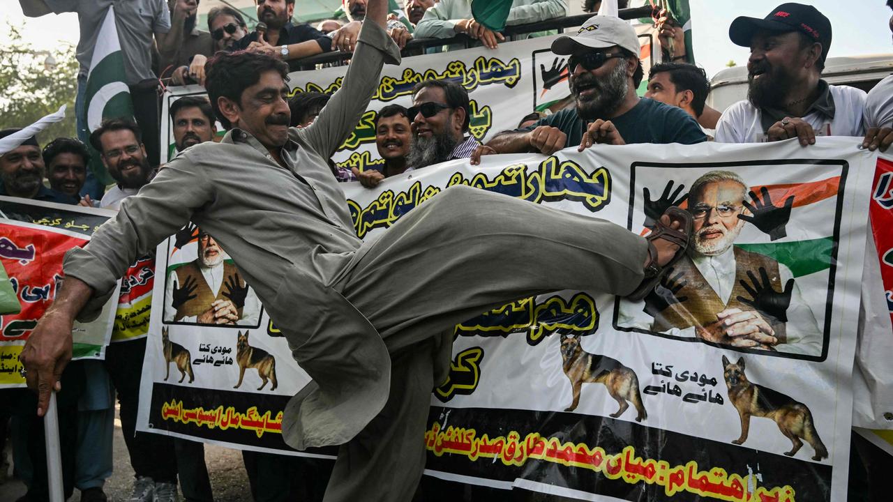 A trader kicking on the picture of India’s Prime Minister Narendra Modi during an anti-India protest in Karachi on April 29, 2025. (Photo by Rizwan TABASSUM / AFP)