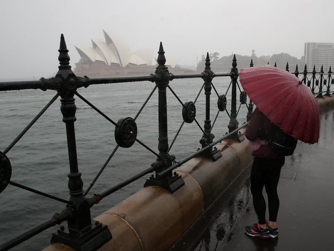 DAILY TELEGRAPH. NOVEMBER, 21, 2021.ÃWet weather is forecast for Sydney this week. A woman looks at the Opera House with an umbrella. Picture: David Swift