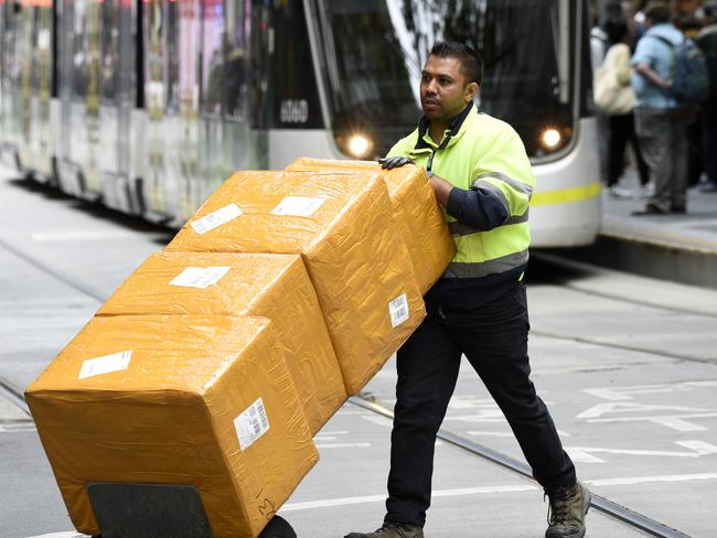 MELBOURNE, AUSTRALIA - NewsWire Photos DECEMBER 15, 2022: ABS generics - A delivery driver with boxes in the Bourke Street Mall in central Melbourne. Picture: NCA NewsWire / Andrew Henshaw
