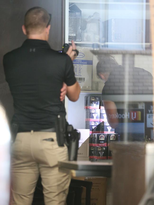 Police search boxes at the Titanic Cafe. Picture: John Grainger