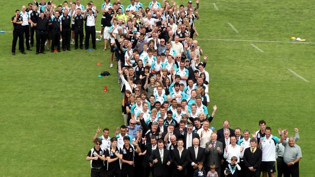 The announcement of a merger between the SANFL Port Adelaide Magpies football club with the AFL Port Adelaide Power football club at Alberton Oval in 2010. Members and officials from both clubs form a big number one on Alberton Oval.