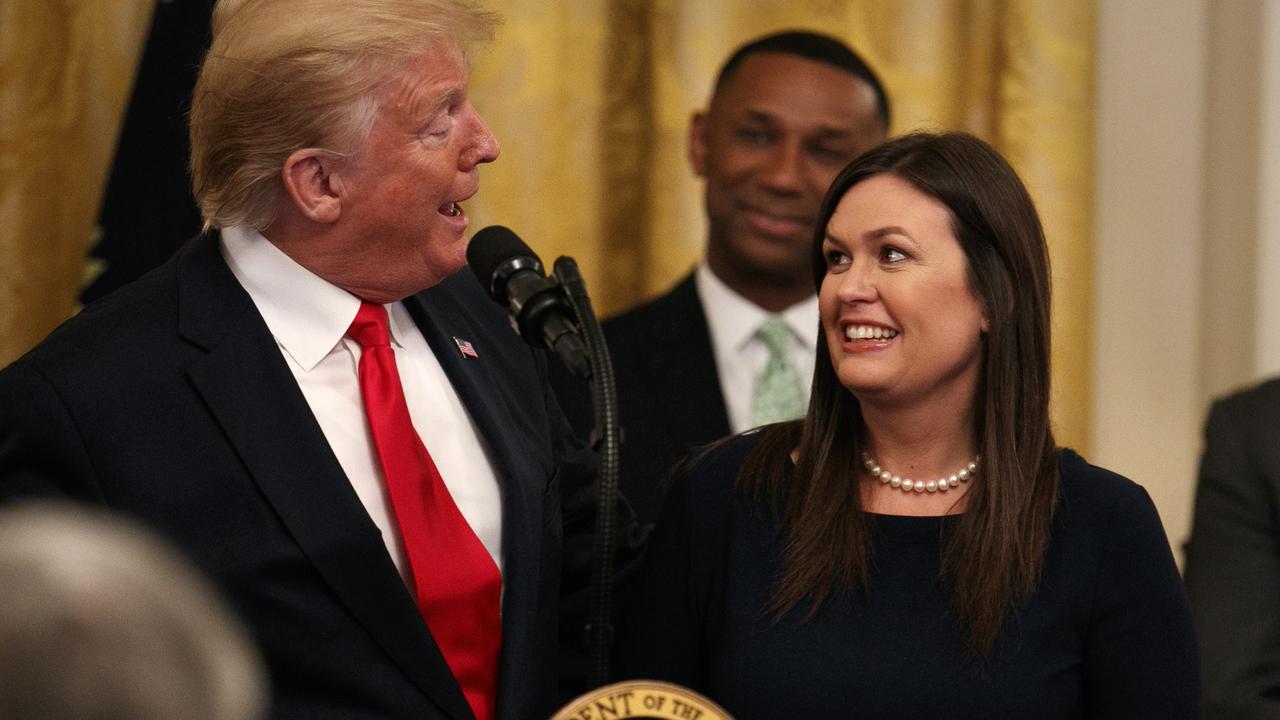 President Donald Trump welcomes White House press secretary Sarah Sanders to the stage. Picture: AP