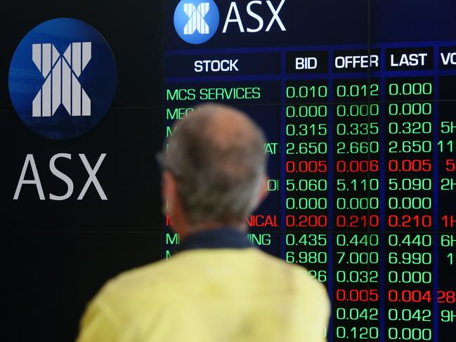 SYDNEY, AUSTRALIA - MARCH 16: A man looks at an electronic board displaying stock information at the Australian Securities Exchange, operated by ASX Ltd. on March 16, 2020 in Sydney, Australia. The ASX dropped more than 7 per cent at opening of trade on Monday as concerns over the COVID-19 fuels further travel restrictions. Strict new border measures to contain the spread of COVID-19 have come into effect Monday, requiring all overseas arrivals to Australia to self-isolate for 14 days. Australia currently has 300 confirmed cases of coronavirus while five people have died  four in NSW and one in Queensland. (Photo by Brendon Thorne/Getty Images)