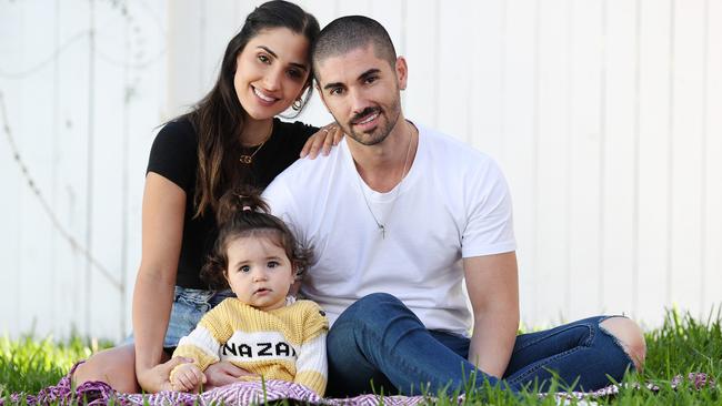 Thessy Kouzoukas and Georgio Batsinilas at home in Camp Hill, Brisbane with daughter Zani before leaving for Greece. Photo: Tara Croser.