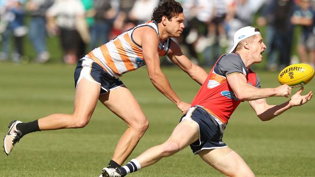 Steve Motlop tackles Scott Selwood during match simulation. Picture: Alison Wynd