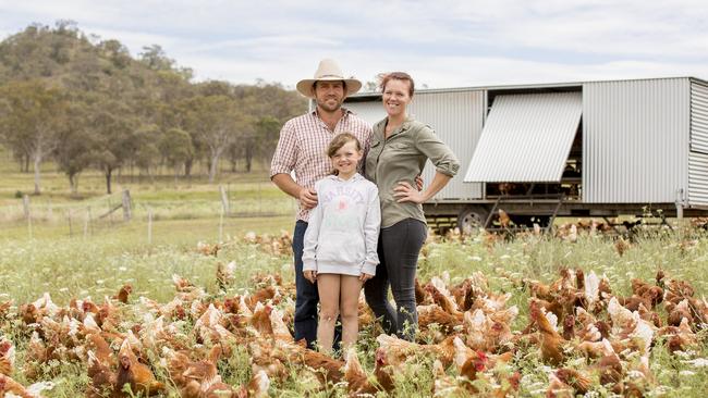 Randal, Juanita and their daughter Bridey with the chickens on their farm at Goomburra in Queensland. Picture: Kim Storey