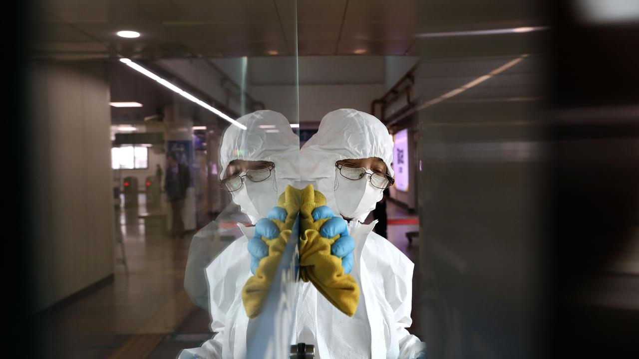 A South Korean disinfection worker wearing protective clothing sprays anti-septic solution to prevent the coronavirus spread in a subway station in Seoul, South Korea. Picture: Chung Sung-Jun/Getty Images