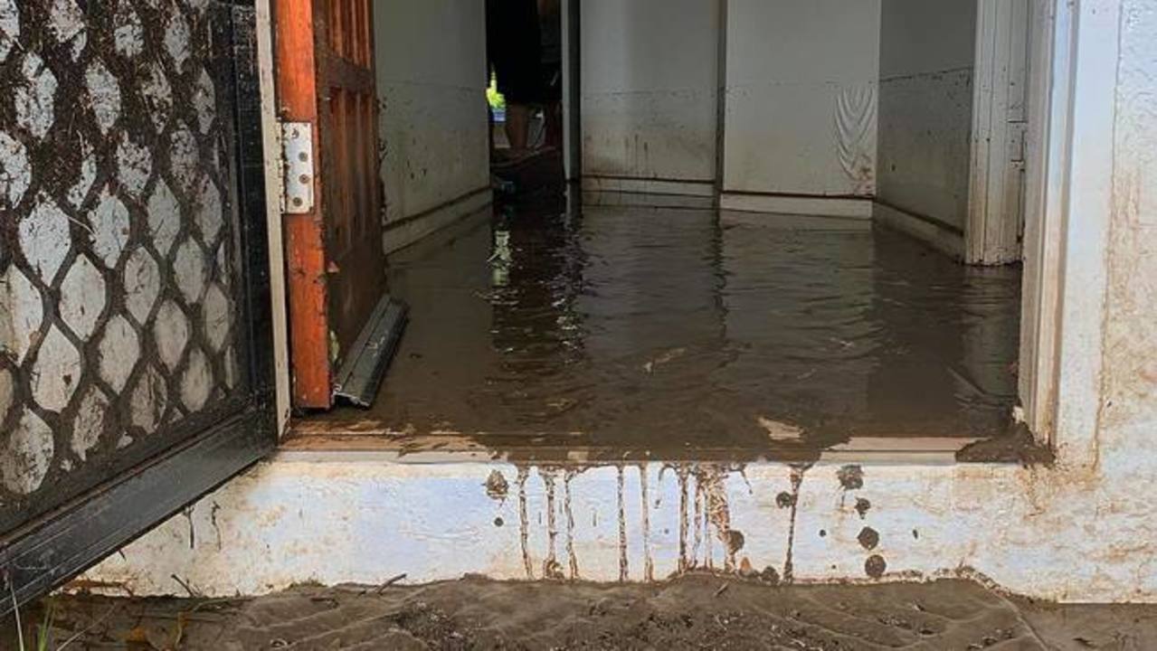 Residents Attempt Muddy Flood Clean-up During Break in Rain