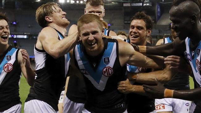 MELBOURNE, AUSTRALIA - MARCH 21: Tom Clurey of the Power leads the Power off the field after a win in the 2021 AFL Round 01 match between the North Melbourne Kangaroos and the Port Adelaide Power at Marvel Stadium on March 21, 2021 in Melbourne, Australia. (Photo by Dylan Burns/AFL Photos via Getty Images)