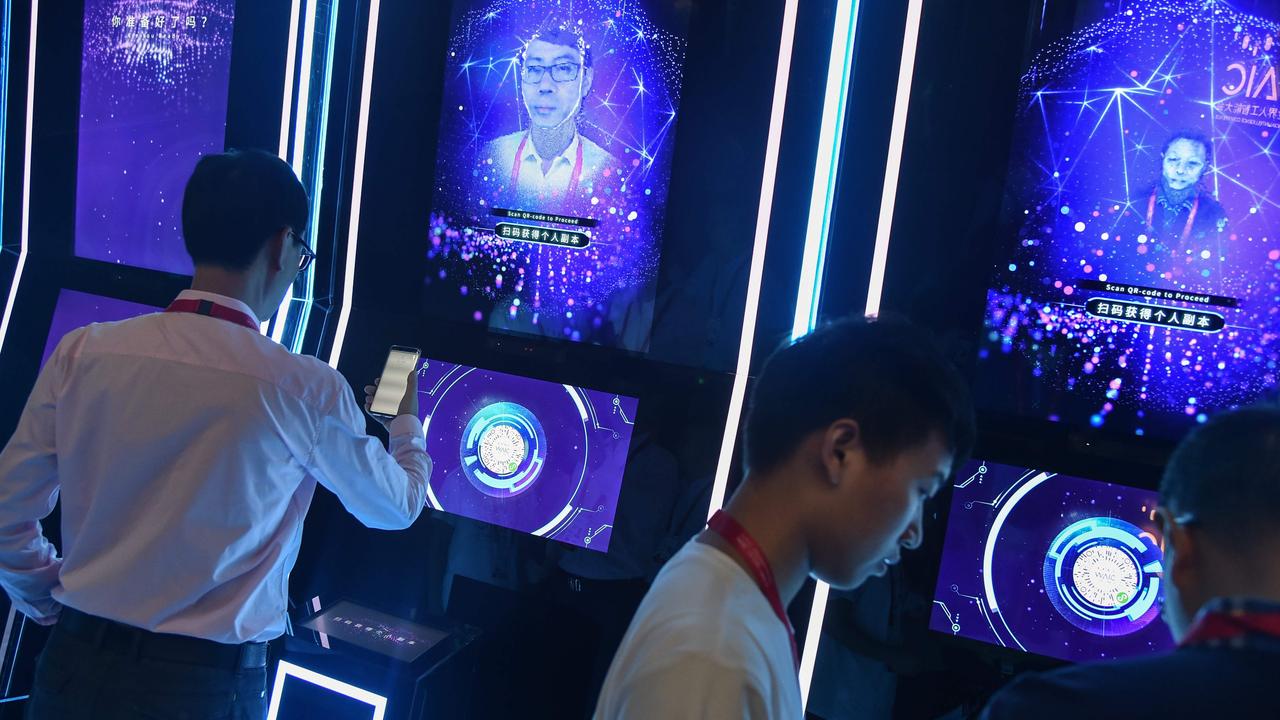 People have their faces scanned as they arrive for the opening ceremony of the World Artificial Intelligence Conference in Shanghai. Picture: Hector Retamal/AFP