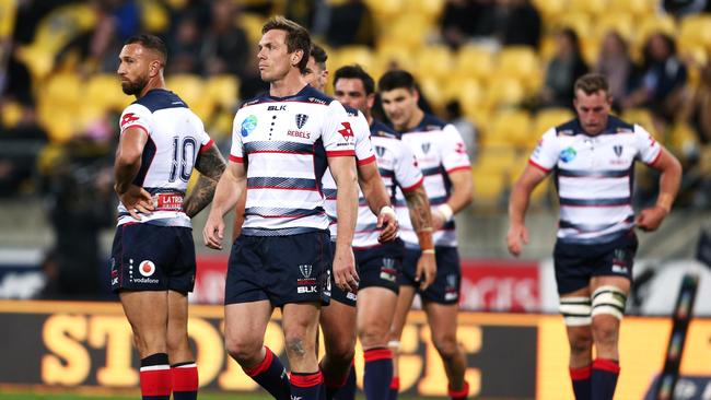 Dane Haylett-Petty of the Rebels and teammates look dejected after a Hurricanes try.