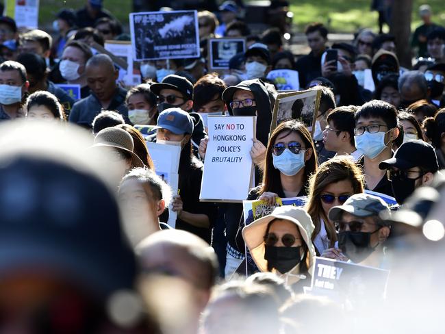 Pro-democracy Hong Kong supporters hold placards during a demonstration in Sydney last year. Picture: AAP