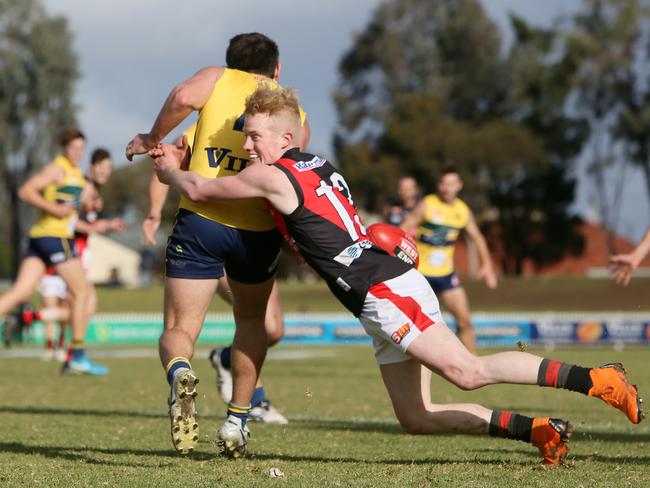 West’s John Noble tries to bring down Eagles opponent Jake Johansen. Picture: AAP/Emma Brasier.