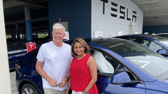 Tesla owners Craig and Linda Thompson from the Gold Coast were among the few lucky ones when they pulled into Coffs Harbour to recharge their vehicle. Picture: Chris Knight