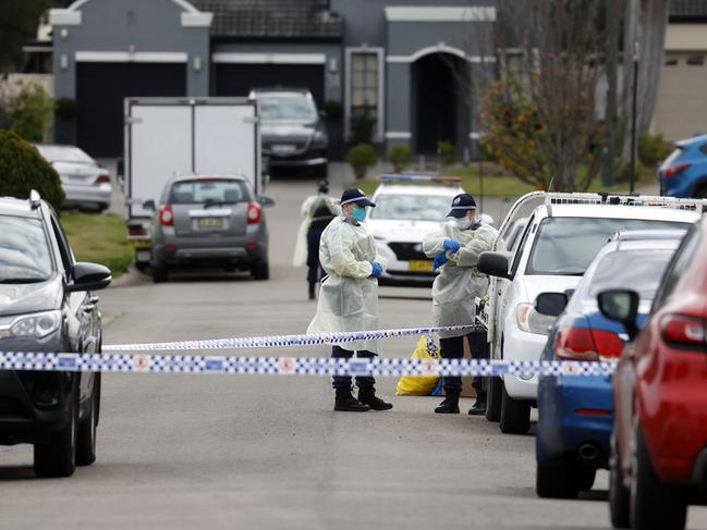 Police officers outside the Sydney home where a woman has died of Covid-19. Picture: Jonathan Ng