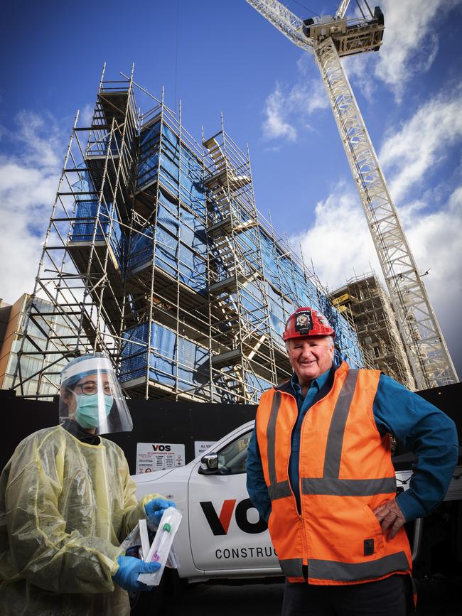 Kevin Harkins at a construction site at Hobart with nurse Vicky Liu in June. Picture: Chris Kidd