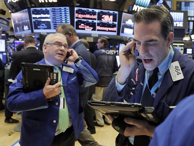 Traders James Dresch, left, and Gregory Rowe work on the floor of the New York Stock Exchange, Monday, Nov. 14, 2016. Stocks are opening modestly higher on Wall Street, led by gains in banks as interest rates continue to rise. (AP Photo/Richard Drew)