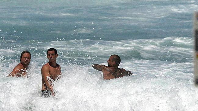 The late Carl Williams (left) playing in the surf with right-hand man Andrew Veniamin (right) and an associate at Surfers Paradise Beach. Gold Coast, Queensland.