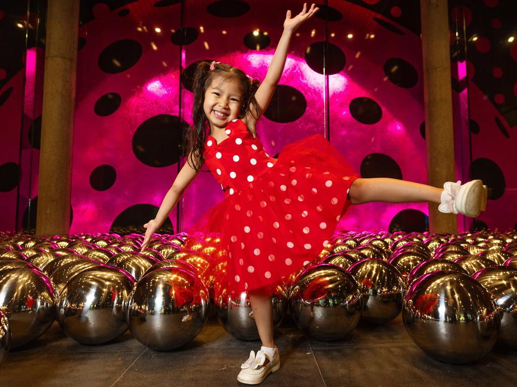 <p>The National Gallery of Victoria (NGV) has unveiled its latest public artwork by Yayoi Kusama, Ascension of Polka Dots on the Trees&mdash;a mesmerising installation featuring over 60 plane trees along St Kilda Road wrapped in vibrant pink-and-white polka dots. Four-year-old Ava Bandara gets an early glimpse of the whimsical exhibition. Picture: Mark Stewart.</p>