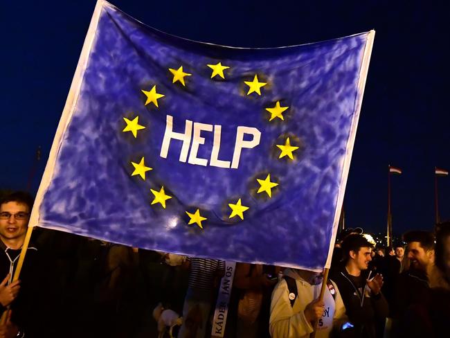 Young protesters take part in a demonstration against a new higher education legislation outside the Presidential Palace in Buda Castle of Budapest on April 10, 2017. Hungarian President Janos Ader approved today a controversial law seen as targeting the respected Central European University founded by US billionaire George Soros, despite protests at home and abroad. The signing of the higher education legislation, the final legal hurdle before it passes into law, came after the largest street demonstration in Hungary in recent years.  / AFP PHOTO / ATTILA KISBENEDEK