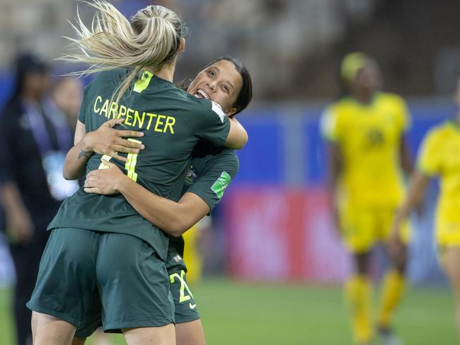 GRENOBLE, FRANCE June 18.  Sam Kerr #20 of Australia, after scoring four goals, celebrates with teammate Ellie Carpenter #21 of Australia at the end of the game during the Jamaica V Australia, Group C match at the FIFA Women's World Cup at Stade des Alpes on June 18th 2019 in Grenoble, France. (Photo by Tim Clayton/Corbis via Getty Images)