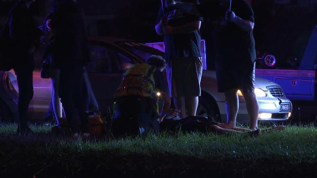 Police and emergency services treating a teen at the scene of a Molendinar crash. Picture: LLN Australia