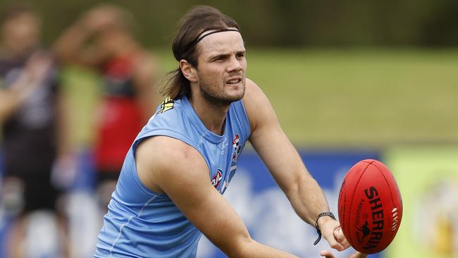 MELBOURNE, AUSTRALIA - APRIL 11: Hunter Clark of the Saints handballs during a St Kilda Saints AFL training session at RSEA Park on April 11, 2024 in Melbourne, Australia. (Photo by Darrian Traynor/Getty Images)