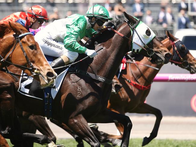 Michelle Payne and Tavi Bay (green silks) charge out of the pack to salute on Oaks Day at Flemington. Picture: Wayne Ludbey