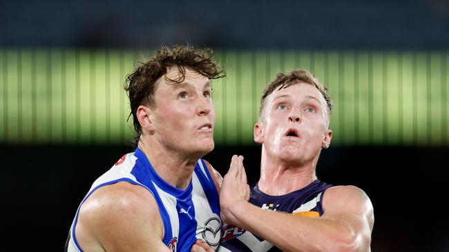 MELBOURNE, AUSTRALIA - MARCH 23: Nick Larkey of the Kangaroos and Josh Treacy of the Dockers compete in a ruck contest during the 2024 AFL Round 2 match between the North Melbourne Kangaroos and the Fremantle Dockers on March 23, 2024 in Melbourne, Australia. (Photo by Dylan Burns/AFL Photos via Getty Images)