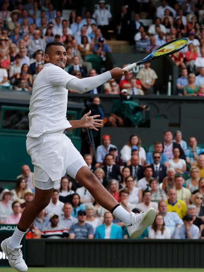 Nick Kyrgios fires back a return against Rafael Nadal at Wimbledon.