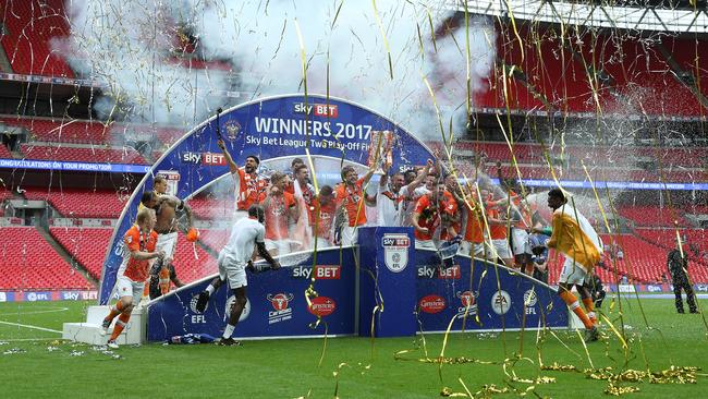 Blackpool players and staff celebrate victory and promotion to League One.