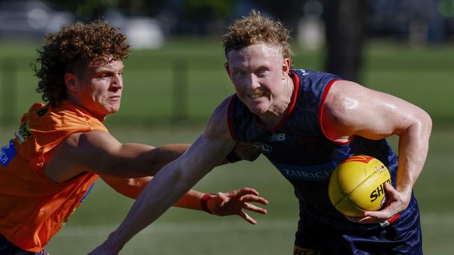 MELBOURNE , AUSTRALIA.February 12 , 2024. Melbourne AFL football training at Goschs Paddock. Clayton Oliver of the Demons fends off Koltyn Tholstrup . Pic: Michael Klein