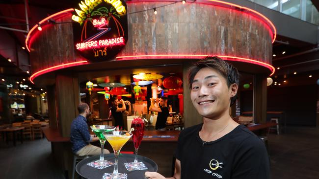 Waiter Tsubasa Yamaoka takes out a round of drinks to customers. Picture Glenn Hampson