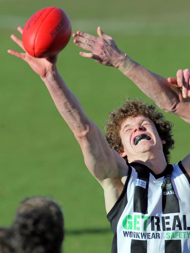 Ben Brown reaches for a tap in his time with Glenorchy in 2012 ...