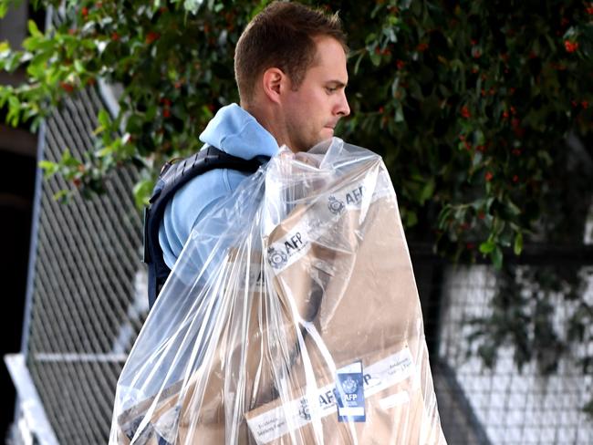 AFP officers remove evidence from an apartment in Ascot Vale. Picture: Nicole Garmston