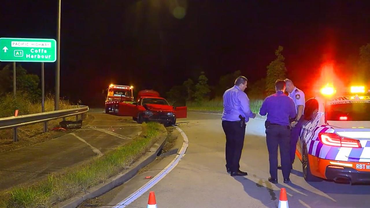 Police investigate a crash that happened in an exit lane from the Pacific Highway at Moonee Beach on March 9, 2022.