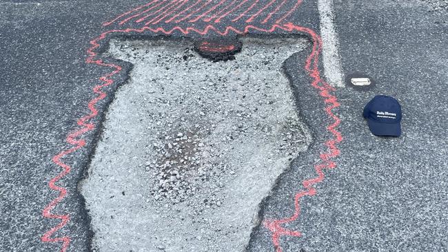 Motorists are having to swerve over solid white lines to avoid a massive pothole near Koumala south of Mackay along the Bruce Highway. Picture: Mitchell Dyer