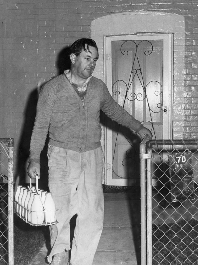 Adelaide milkman Murray Williams, 42, of Windsor Gardens, delivering milk bottles to homes on his early morning round in 1971.
