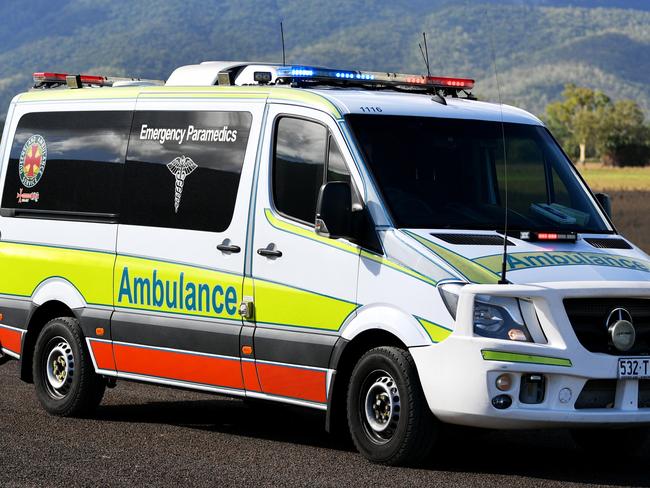 Emergency services attend a fatal car crash on the Bruce Highway, south of Townsville at Mount Surround. Garbage truck driver being looked over by paramedics.  Picture: Alix Sweeney