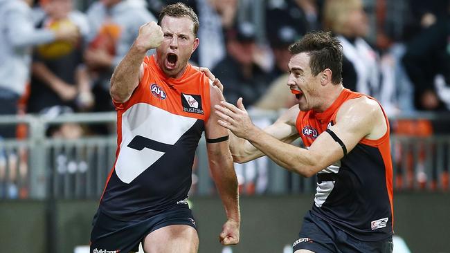 Steve Johnson and Jeremy Cameron celebrate his match-winning goal against Collingwood.