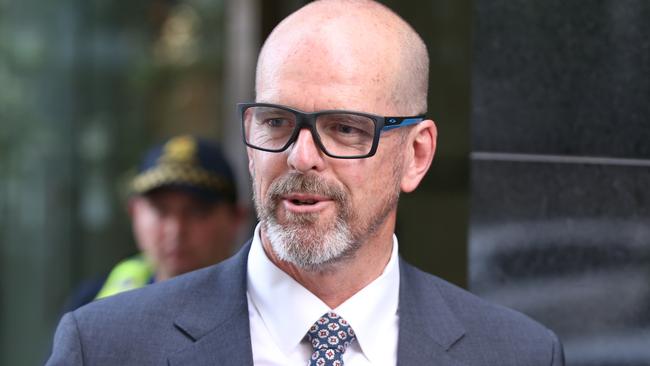 Former Victoria Police Chief Commissioner Simon Overland leaves the Royal Commission on Wednesday. Picture: David Crosling/AAP