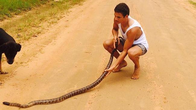 Richmond player Daniel Rioli with a snake on the Tiwi Islands