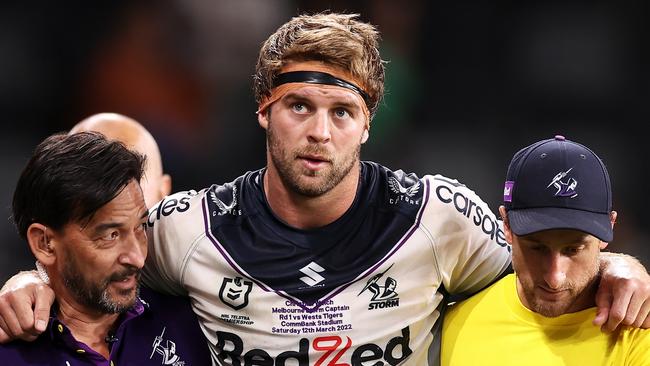 SYDNEY, AUSTRALIA - MARCH 12:  Christian Welch of the Storm is helped from the field during the round one NRL match between the Wests Tigers and the Melbourne Storm at CommBank Stadium, on March 12, 2022, in Sydney, Australia. (Photo by Mark Kolbe/Getty Images)