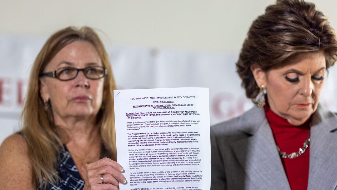 Mamie Mitchell and lawyer Gloria Allred hold a copy of safety recommendations for the use of live ammunition at a press conference on Wednesday. Picture: David McNew/AFP