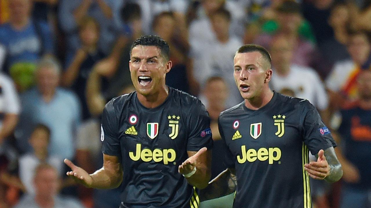 Juventus' Portuguese forward Cristiano Ronaldo (L) reacts next to Juventus' Italian midfielder Federico Bernardeschi after receiving a red card