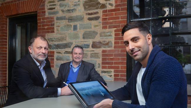 Sean Pickersgill from the Universal Bridging Consortium, Jason Semanic from The Space Laboratory and John Noonan from the Universal Bridging Consortium with an artist’s impression of a bridge they want to build between Cape Jervis and Kangaroo Island. Picture: AAP Image/Brenton Edwards