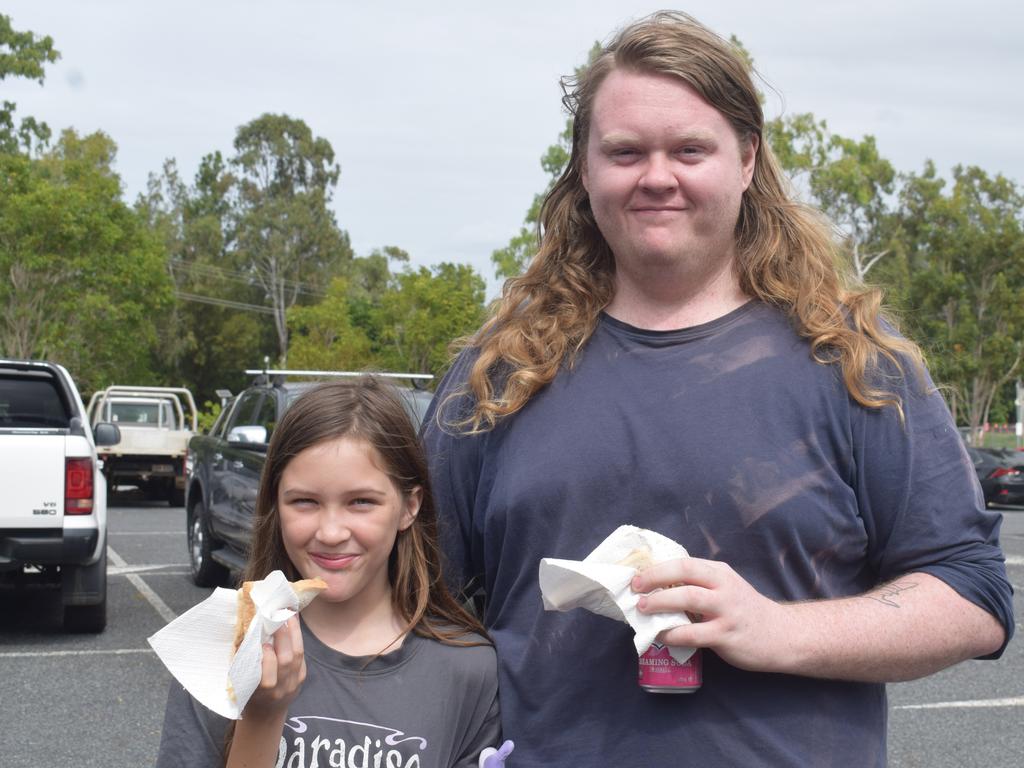 Nova Watkins and Jayden Watkins, 10, enjoying a democracy sausage at the 2025 federal polling booth in Rockhampton. Pic: Gabriel Garcia