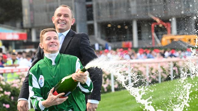 James McDonald and Trainer Chris Waller celebrate spraying champagne after Via Sistina won the Cox Plate. Picture: Vince Caligiuri/Getty Images.