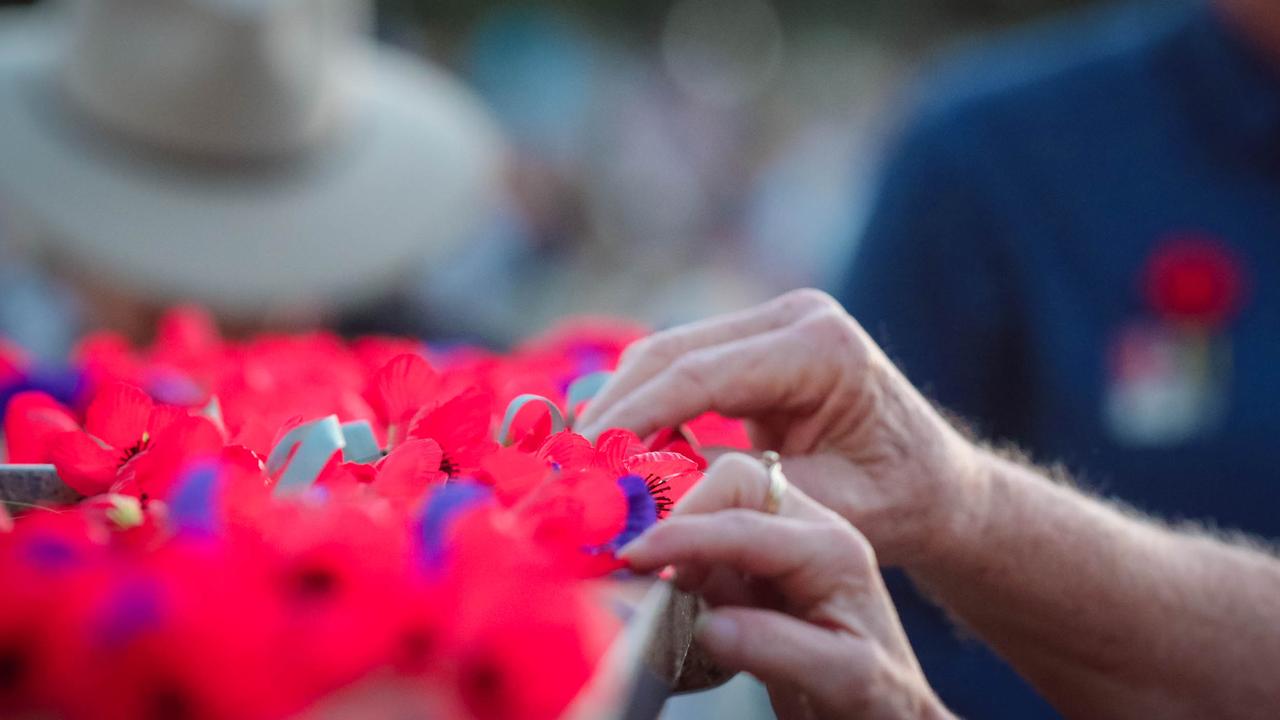 Poppys being laid at The Dawn Service at Darwins Cenotaph commemorating ANZAC Day 2021. Picture Glenn Campbell